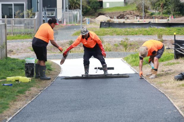 Contractors lay the Porous Lane footpath at Jack’s Landing.